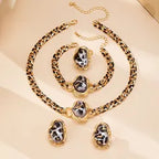 Jewelry set with necklace, bracelet, and earrings on a beige background