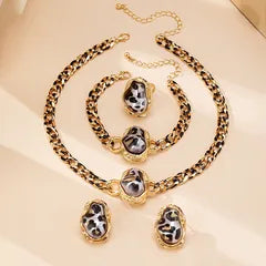 Jewelry set with necklace, bracelet, and earrings on a beige background