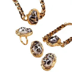Gold jewelry set with heart-shaped gemstones on a white background