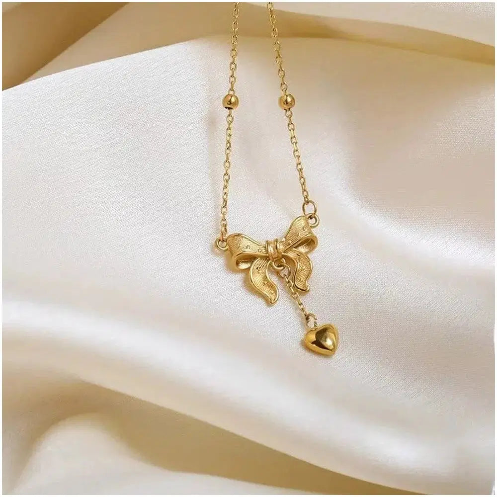 Golden Bow Knot Heart Tassel Pendant Necklace, Size: Free, a delicate gold-toned chain necklace featuring an elegant bow knot with a small heart tassel charm, perfect for fashion jewelry lovers.