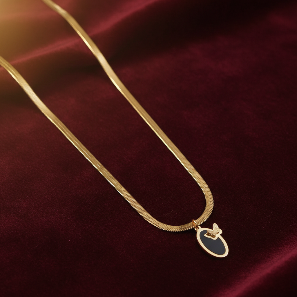 Gold Herringbone Butterfly Oval Pendant Necklace on Dark Velvet