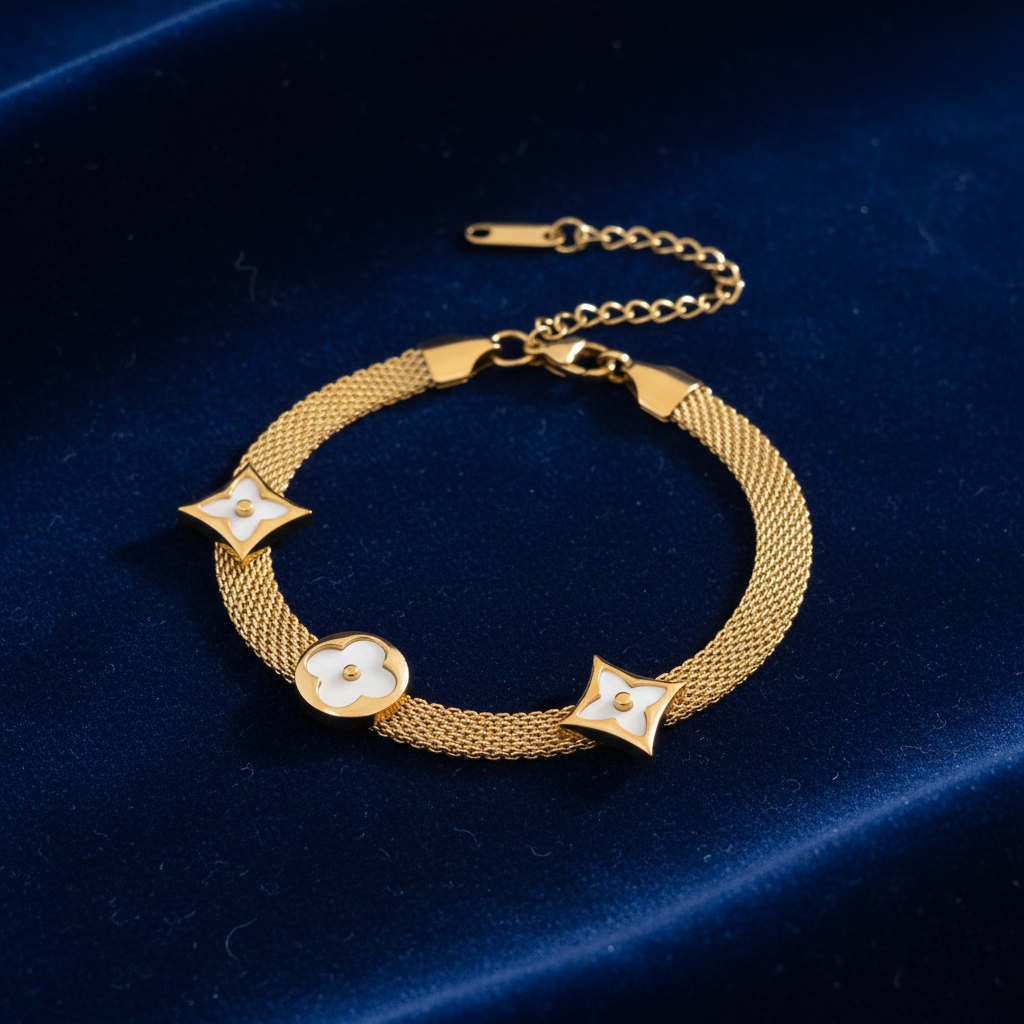 Gold Mesh Bracelet with White Floral Charms on Dark Velvet