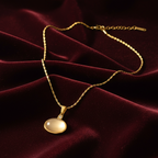 Gold Oval Cabochon Pendant Necklace on Dark Velvet