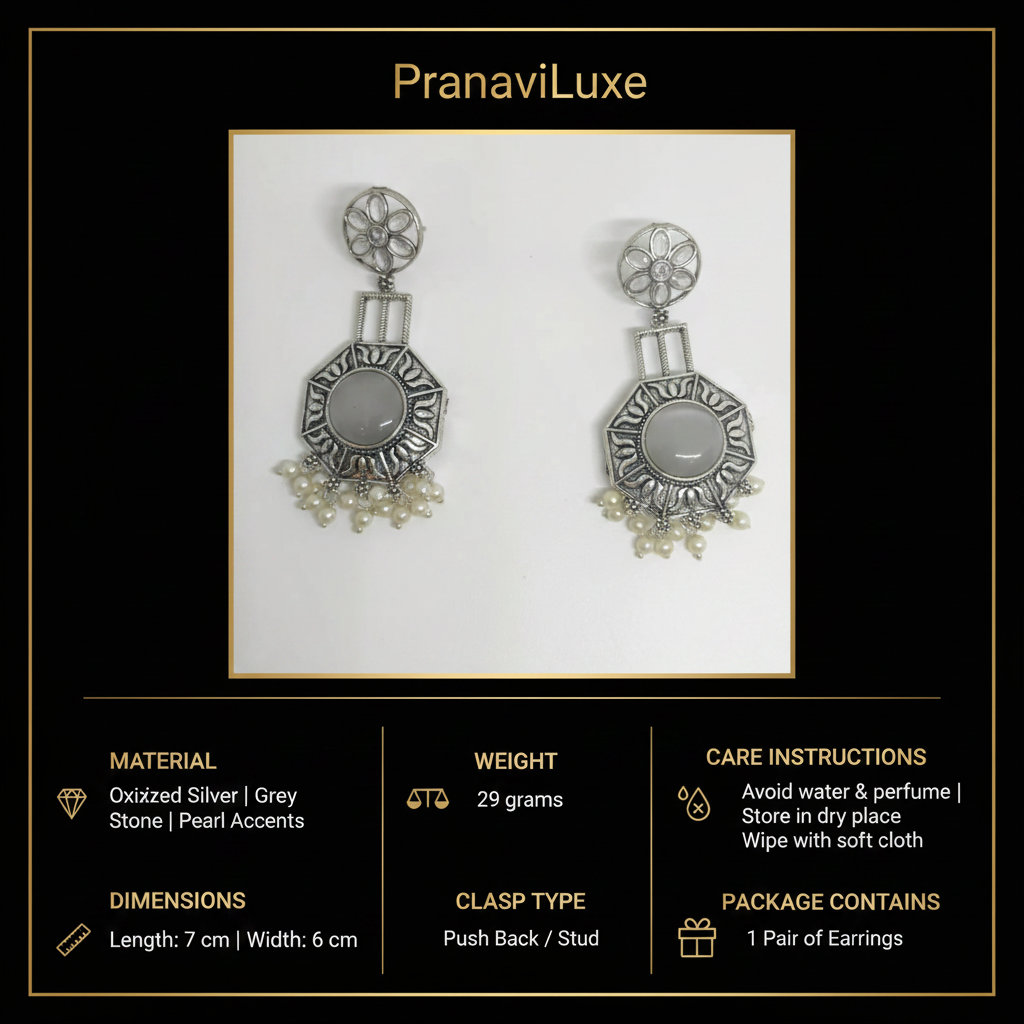 A pair of oxidized silver statement earrings with grey stone accents and pearl-like dangling details, shown on a white background within a black branded card. The card includes the brand name PranaviLuxe and product details such as material, weight, dimensions, care instructions, and package contents.