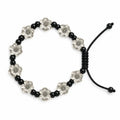A beaded stretch bracelet featuring alternating black round beads and silver-toned flower-shaped beads, with a black adjustable cord closure, shown on a plain white background.