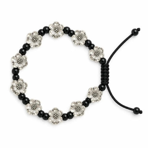A beaded stretch bracelet featuring alternating black round beads and silver-toned flower-shaped beads, with a black adjustable cord closure, shown on a plain white background.