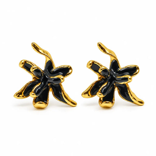 A pair of gold and black flower-shaped stud earrings on a clean white background.