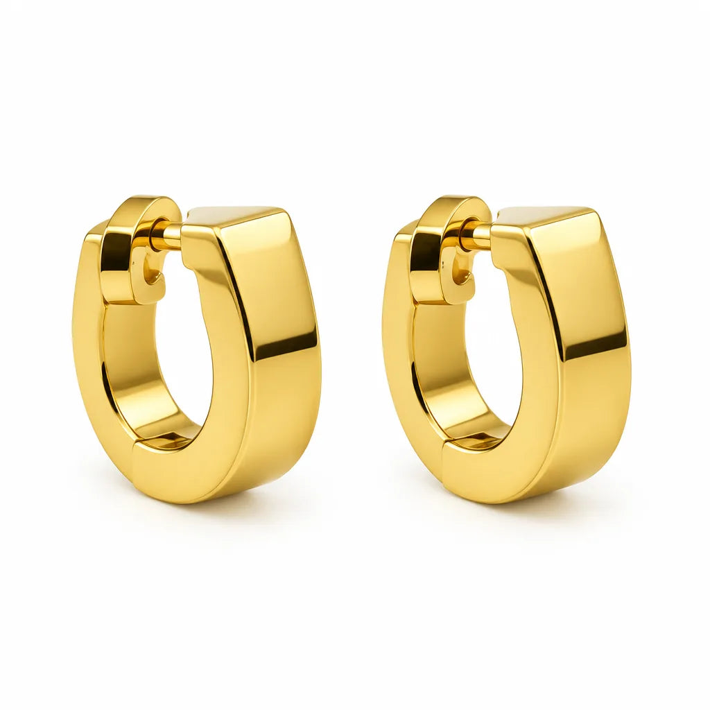 A pair of polished yellow gold huggie hoop earrings on a clean white background.