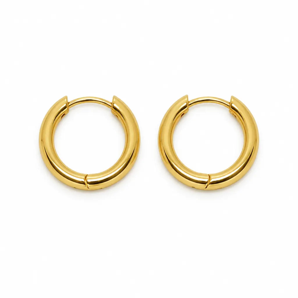 A pair of polished gold huggie hoop earrings on a clean white background.