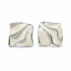 A pair of square stud earrings with a wavy, fluid design, featuring a glossy cream-colored inlay set in a polished silver-tone metal, shown against a plain white background.