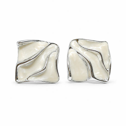 A pair of square stud earrings with a wavy, fluid design, featuring a glossy cream-colored inlay set in a polished silver-tone metal, shown against a plain white background.