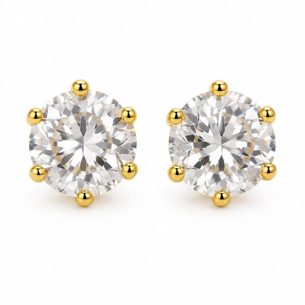 A pair of round-cut diamond stud earrings in a six-prong yellow gold setting, shown on a clean white background.