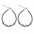 A pair of black beaded anklets with silver-tone flower charms and adjustable chain closures, displayed on a clean white background.