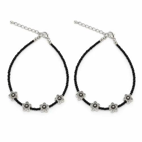 A pair of black beaded anklets with silver-tone flower charms and adjustable chain closures, displayed on a clean white background.
